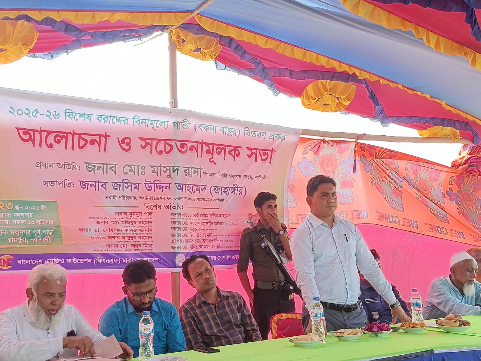 Awareness meeting; speaker standing at panel.